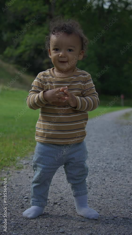A happy and carefree toddler joyfully playing outdoors in the beautiful nature around them A happy and carefree toddler joyfully playing outdoors in the beautiful nature around them