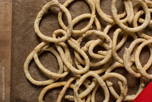 Top view of fried corn rings snack on a wood background, Overhead view of nigerian kokoro egba corn snack on a chopping board photo