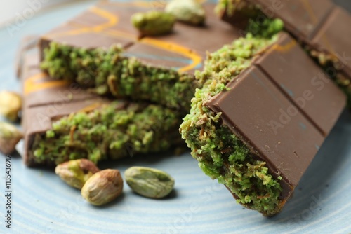 Canvas Print Pieces of Dubai chocolate bar with pistachios and knafeh on plate, closeup