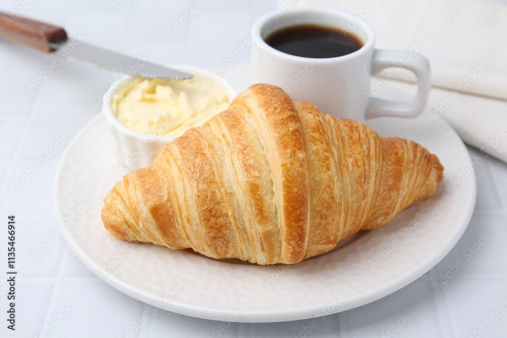 Tasty fresh croissant served with butter and cup of coffee on white tiled table, closeup Tasty fresh croissant served with butter and cup of coffee on white tiled table, closeup