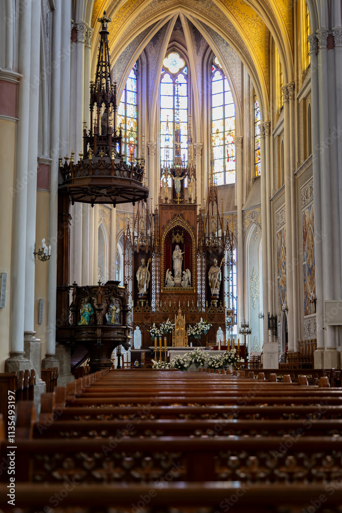 Fototapeta premium Majestic Church Interior with Ornate Altar and Stained Glass Windows