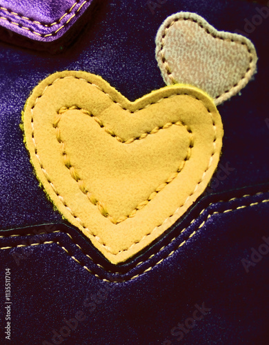 Leather patches, accessories in the shape of hearts on dark. Repairing hole in textile photo