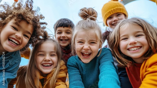 Joyful Group of Children Laughing Together in Outdoor Playground on a Bright Sunny Day