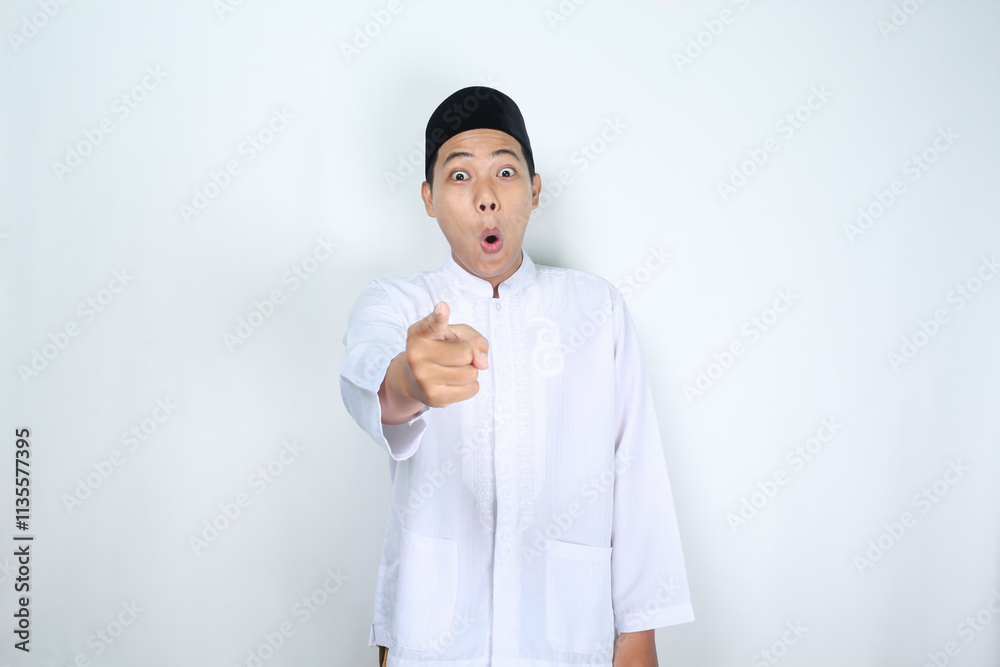 shocked asian man muslim pointing forward to camera isolated on white background shocked asian man muslim pointing forward to camera isolated on white background