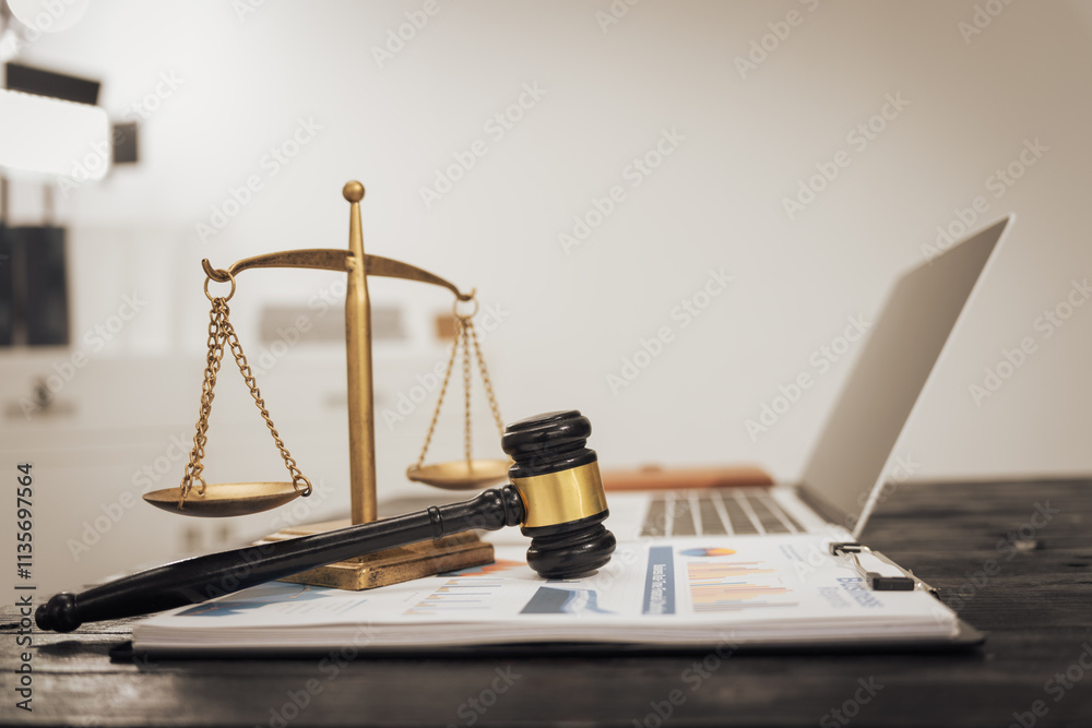 A lawyer's desk featuring a judge's hammer, an open notebook, and the Scales of Justice, symbolizing law, legal services, and criminal justice. No people are present A lawyer's desk featuring a judge's hammer, an open notebook, and the Scales of Justice, symbolizing law, legal services, and criminal justice. No people are present