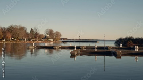 Landscape scene of a Fishing boat leaving sLake Couchiching, Orillia, Ontario, Canada with clear sky photo