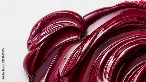 Soft flowing swirls of maroon paint