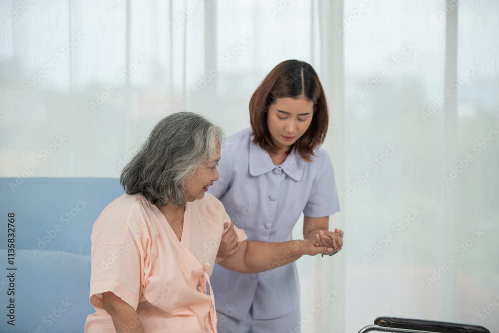 Asian nurse pushing senior female patient in a wheelchair at the hospital ward Asian nurse pushing senior female patient in a wheelchair at the hospital ward