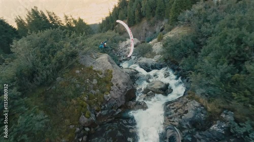 An extreme paragliding pilot flying near a majestic mountain, showcasing breathtaking aerial views of the surrounding landscape. photo