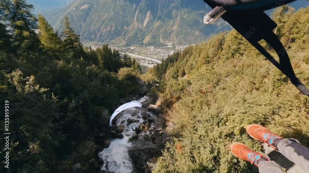 An extreme paragliding pilot flying near a majestic mountain, showcasing breathtaking aerial views of the surrounding landscape.