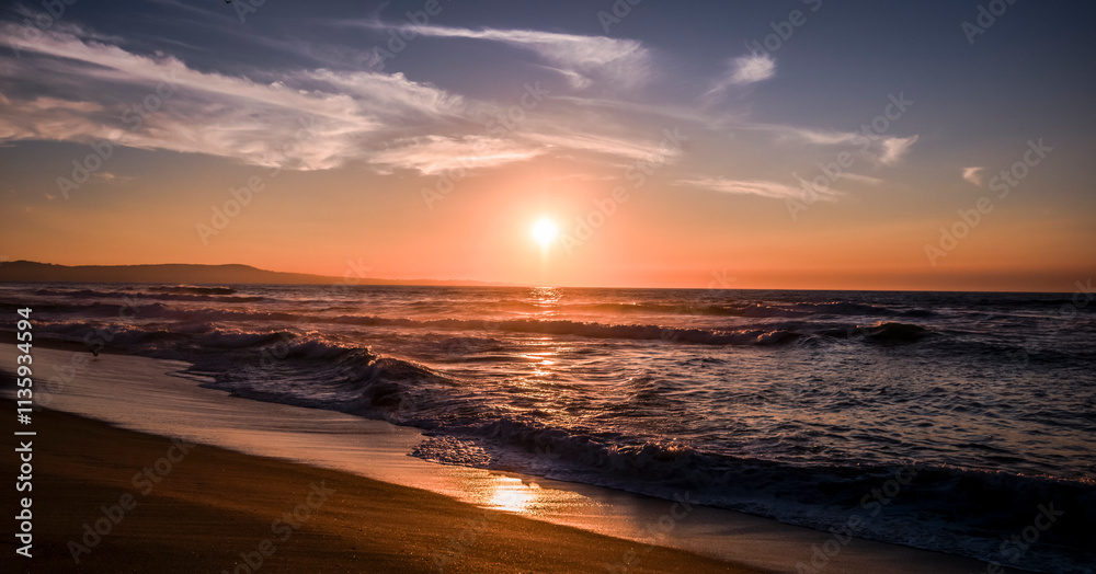 Sunset over Monterey Bay. Bright red setting sun with gentle waves Sunset over Monterey Bay. Bright red setting sun with gentle waves