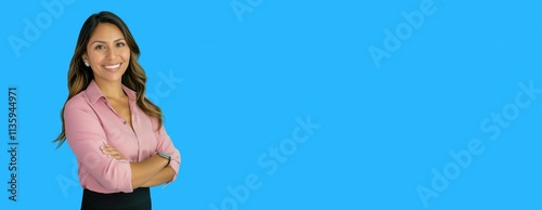 Confident professional woman smiling against a vibrant blue background, offering space for text or design elements. Ideal for corporate, marketing, or motivational content creation. photo