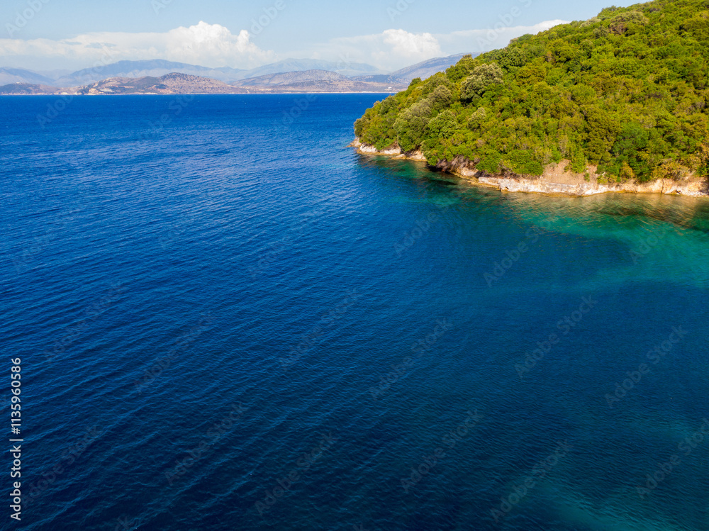 Tranquil blue seascape with lush green coastal forest. Tranquil blue seascape with lush green coastal forest.