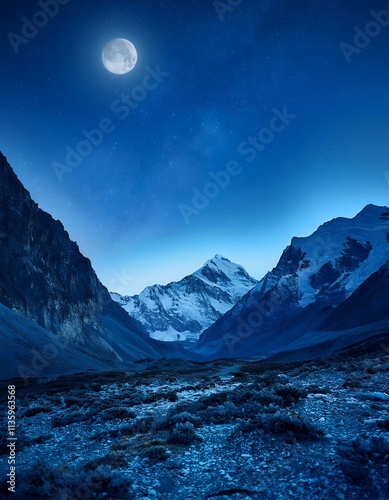 A breathtaking night scene of snow-capped under a full moon. The serene landscape exudes tranquility.