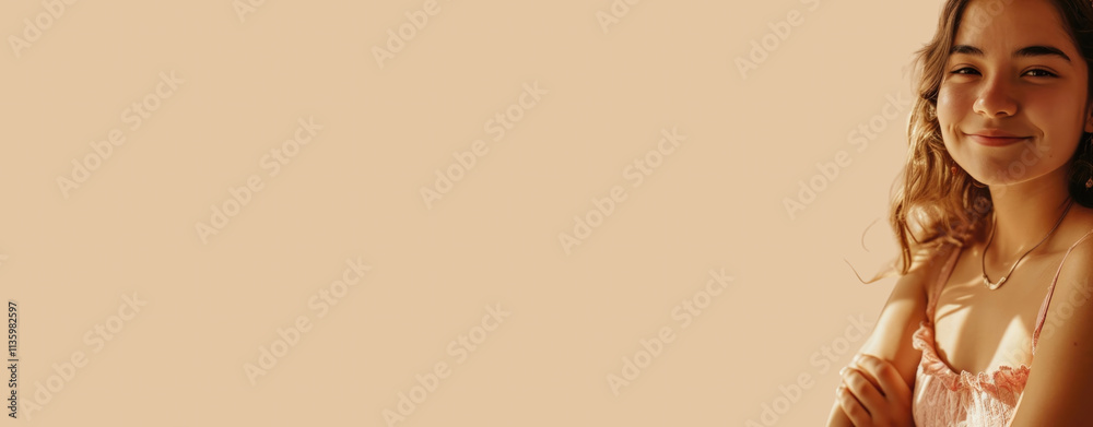 Young woman smiling against a warm beige background with ample space for text or designs Young woman smiling against a warm beige background with ample space for text or designs