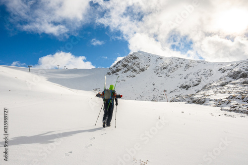 Skier Hiking Through Snowy Slopes at Parnassos Mountain photo