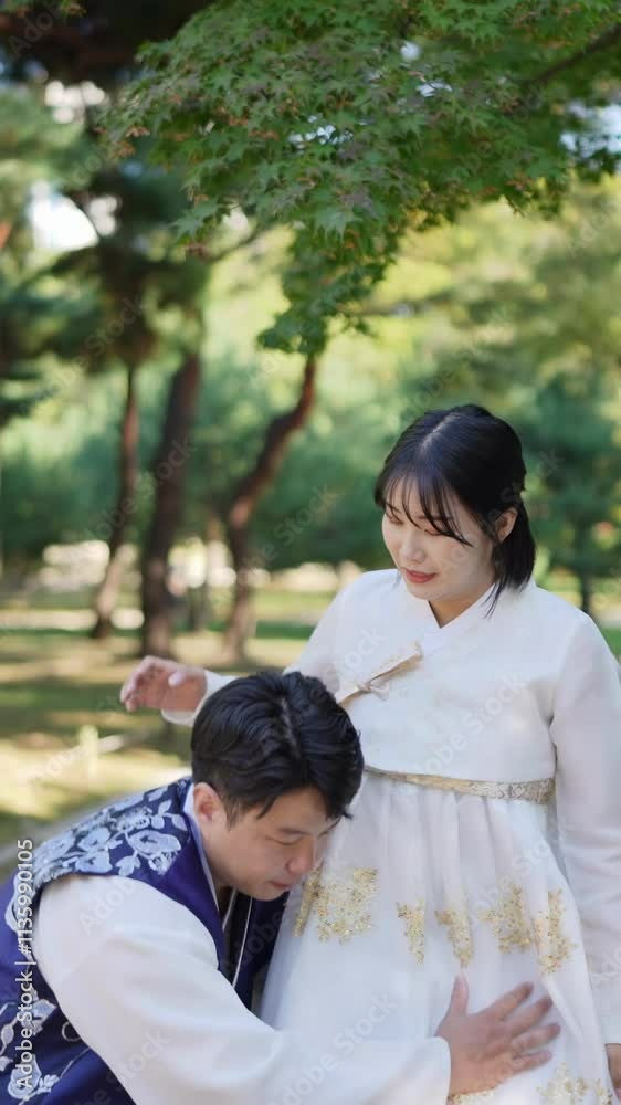 A Korean couple, a man in his 30s holding a woman in her 20s, at a historical park in Seoul, South Korea. Vertical slow motion video. A Korean couple, a man in his 30s holding a woman in her 20s, at a historical park in Seoul, South Korea. Vertical slow motion video.