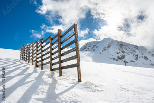 Wooden Fence on Snowy Slopes at Parnassos Mountain photo