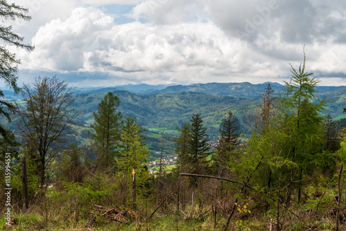 Klubina villlage wiith hills of Kysucke Beskydy mountains from hiking tral between sedlo Korchan and Hladky vrch in Kysucka vrchovina mountains in Slovakia photo