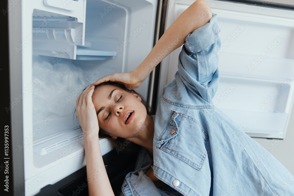 Exhausted woman feeling overwhelmed in front of an open refrigerator, showcasing emotions of stress and fatigue Ideal for themes of wellness and mental health Exhausted woman feeling overwhelmed in front of an open refrigerator, showcasing emotions of stress and fatigue Ideal for themes of wellness and mental health