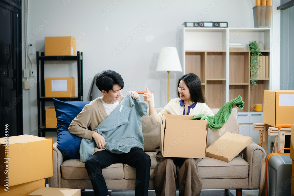 Young couple organizing belongings in a cozy home with boxes and luggage. Perfect for themes of moving