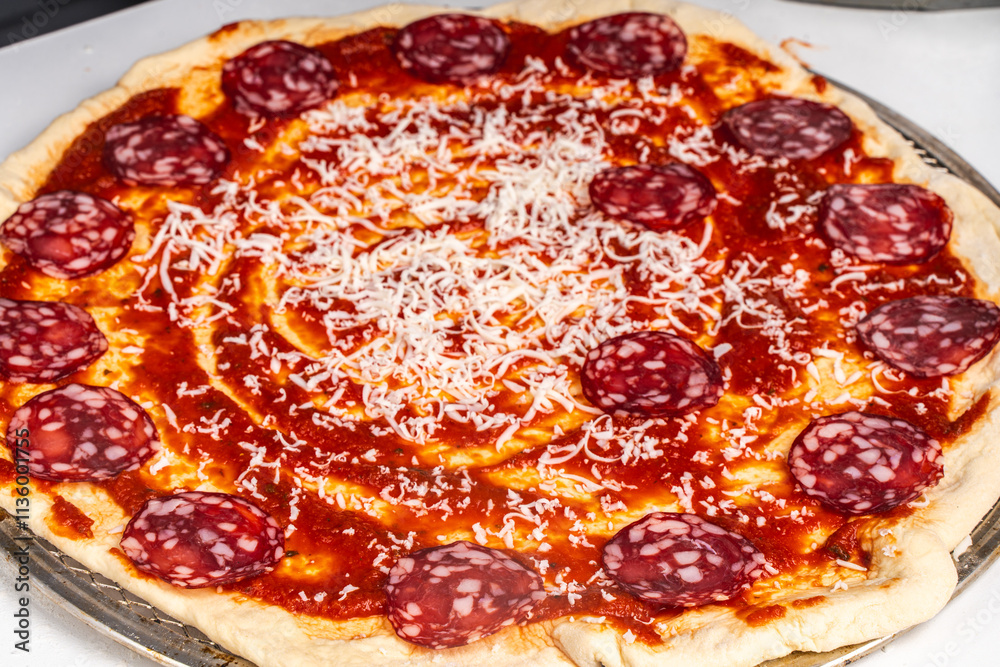 Homemade freshly baked pepperoni pizza on a white background. Close-up, chosen focus. Homemade freshly baked pepperoni pizza on a white background. Close-up, chosen focus.