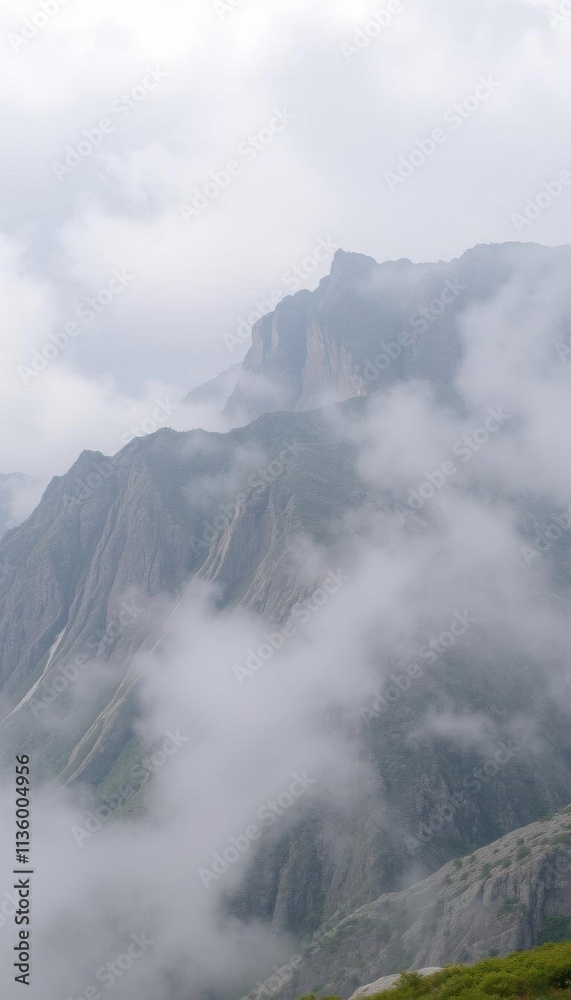 a grassy hill with a mountain in the background a grassy hill with a mountain in the background