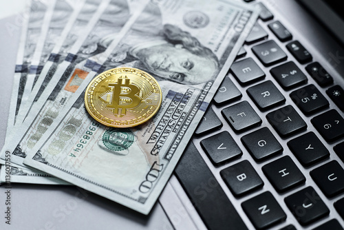 Gold bitcoin coins, us dollars, laptop keyboard close up. photo