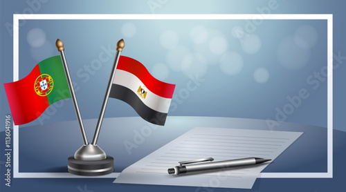 Portugal and EGYPT National flags on small table with bokeh background, cooperative relationship