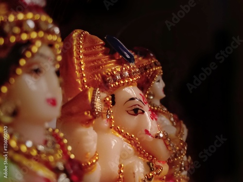 closeup of lord ganesh idol/vinayakar sculpture for ganesh chathurthi/ganapathi is the most workshipped god in indian culture/ganesha is the god of beginnings and fortune isolated over black backdrop photo