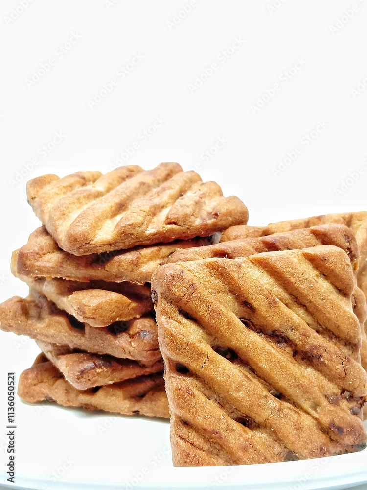 delicious freshly baked chocochip cookies on a plate isolated over white background.sugar chocolate biscuits stacked.sweet foods cause diabetes.tempting tasty baked cookies ready to be served. delicious freshly baked chocochip cookies on a plate isolated over white background.sugar chocolate biscuits stacked.sweet foods cause diabetes.tempting tasty baked cookies ready to be served.