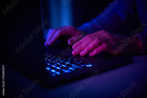 Male hands are typing on a laptop keyboard.