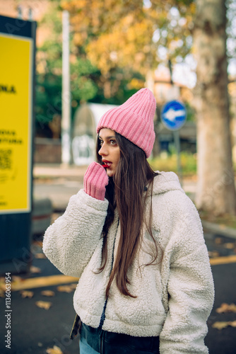 A Young Woman Standing in a Trendy Outfit Surrounded by a Beautiful Autumn Background