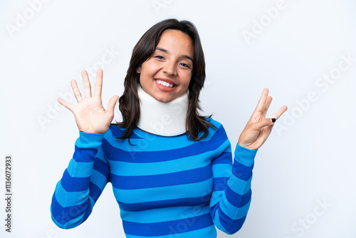 Young hispanic woman wearing neck brace isolated on white background counting eight with fingers photo