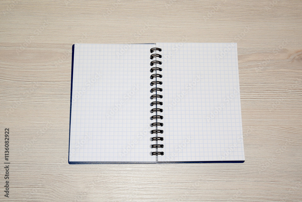 Business composition. Open ring binder lies on a wooden table
Business composition. Open ring binder lies on a wooden table