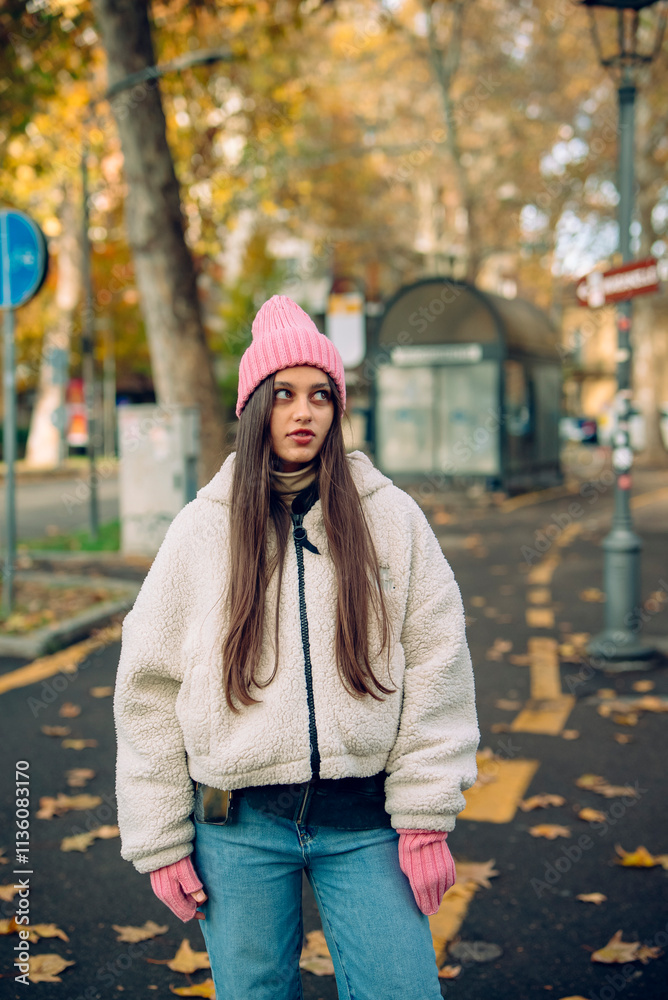 A Young Woman Showcased in Stylish Winter Fashion Strolling Along a Busy City Street A Young Woman Showcased in Stylish Winter Fashion Strolling Along a Busy City Street