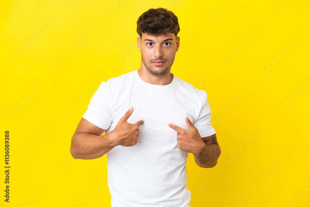 Young caucasian handsome man isolated on yellow background pointing to oneself Young caucasian handsome man isolated on yellow background pointing to oneself
