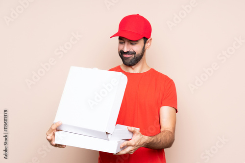 Man holding a pizza over isolated background