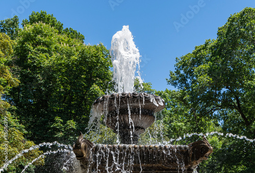 Frogs Fountain is located on central alley in central park. Two bowls of fountain are filled with water. Streams of water flow in different directions. Stavropol, Russia - May 23, 2024 photo