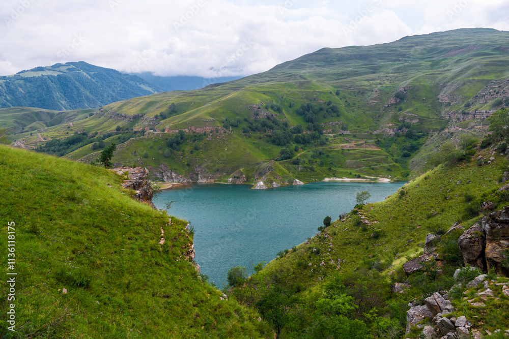 Picturesque view of the mountain lake Gizhgit in the shape of a heart with azure water. Caucasus Picturesque view of the mountain lake Gizhgit in the shape of a heart with azure water. Caucasus
