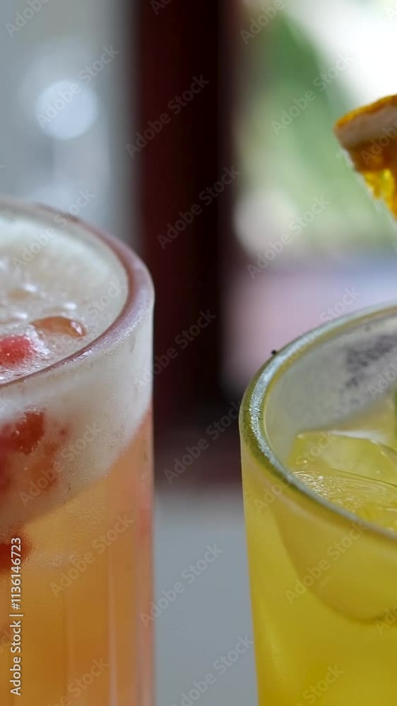 Refreshing summer soft lemonade drink with lemon, citrus, orange, grapefruit, mint, water and ice, glasses with lemonade rotating. Refreshing soft drink Lemon. Vertical video for stories.