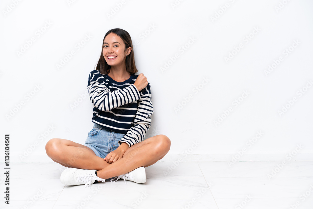 Young caucasian woman sitting on the floor isolated on white background celebrating a victory Young caucasian woman sitting on the floor isolated on white background celebrating a victory