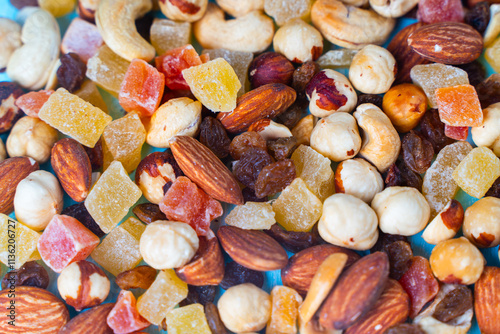 Background with the texture of a mixture of various nuts and candied fruits. Close-up photo