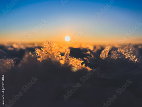 Frosty air and frozen lake surface in a beautiful sunset landscape. Beautiful ice shapes and sunlight. Photo from Sotkamo, Finland.