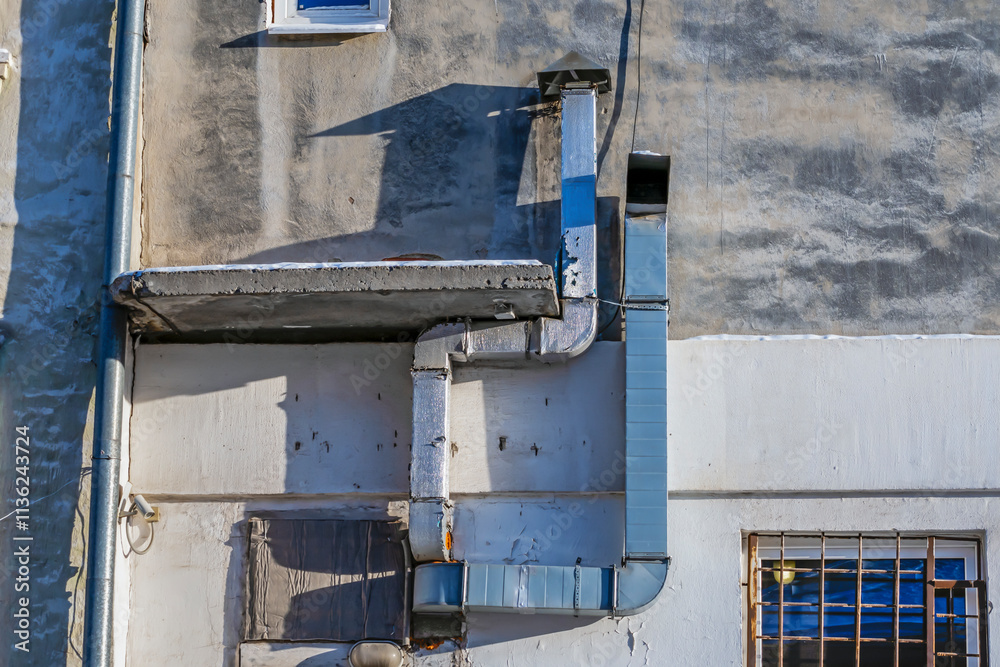 Ventilation pipes on the wall of the building on a winter day Ventilation pipes on the wall of the building on a winter day