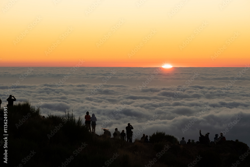 Obraz premium People above the clouds during sunrise