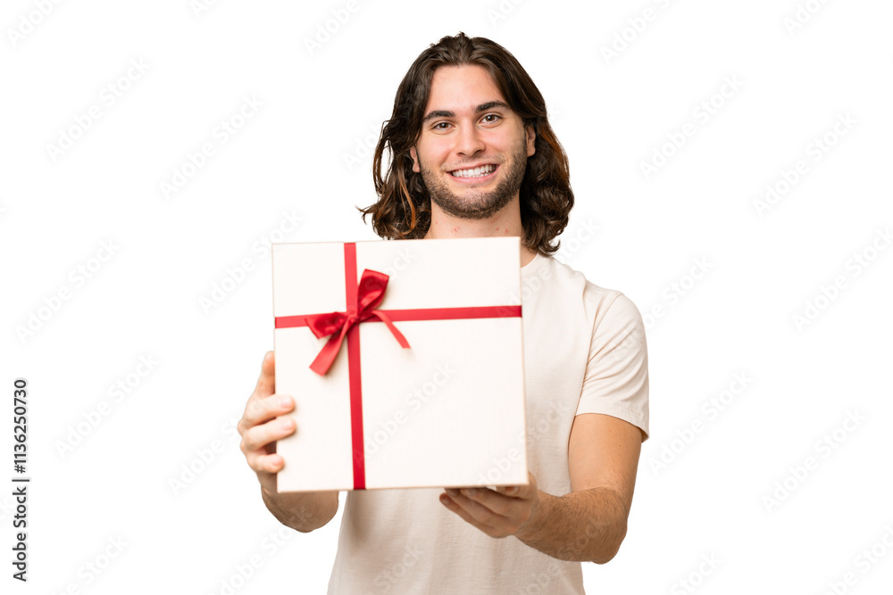 Young handsome man holding a gift over isolated background with happy expression Young handsome man holding a gift over isolated background with happy expression