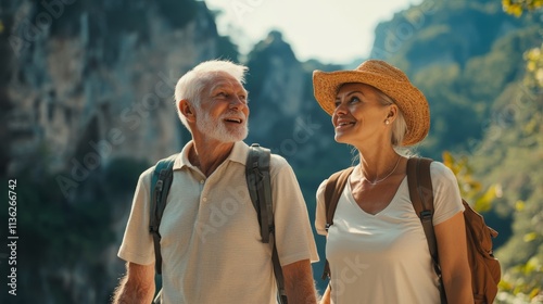 A joyful elderly couple enjoys a moment together while hiking in a scenic, lush landscape.