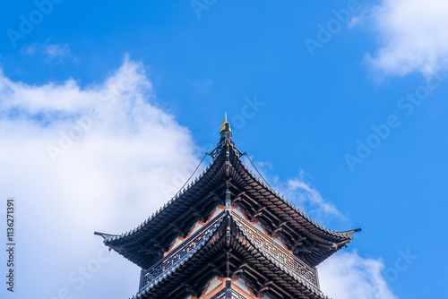 Ancient Chinese pagoda under blue sky and white clouds