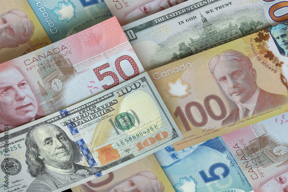 Obraz premium US dollar and Canadian dollar bills. Cash. Financial Concept.